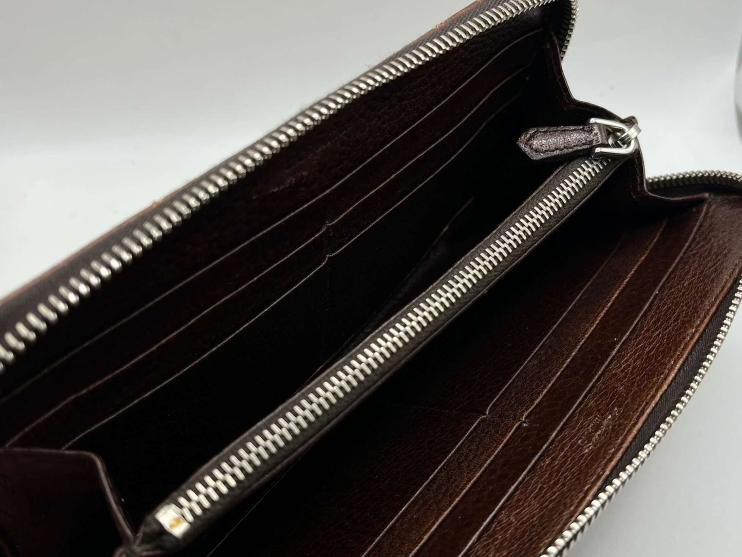 PRADA leather longwallet in brown with zipper and card slots.