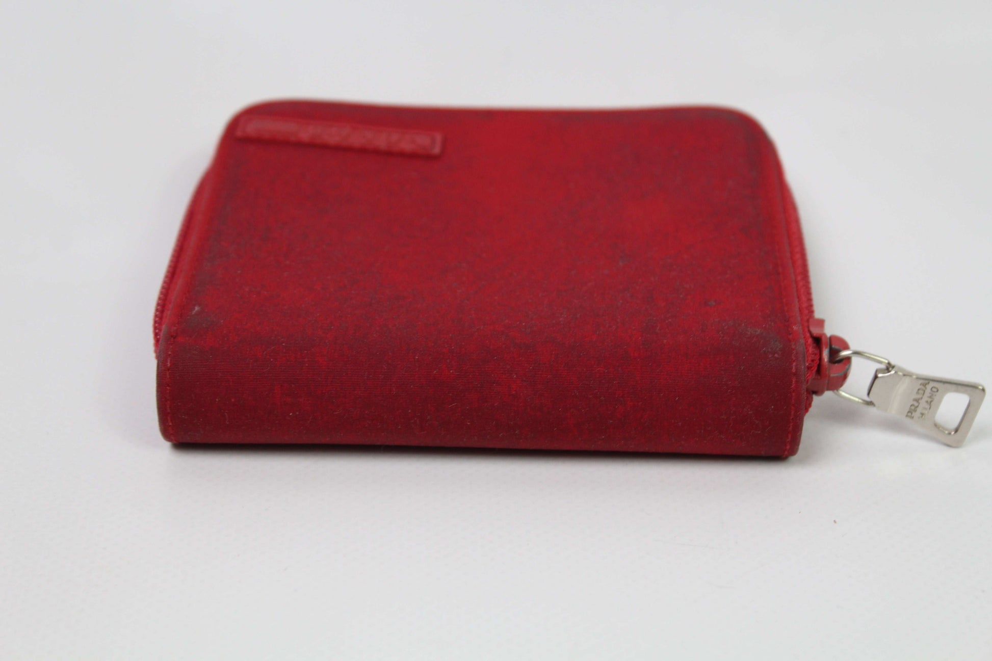 Red PRADA sports wallet, nylon and cotton material, used condition 6/10 with exterior marks.