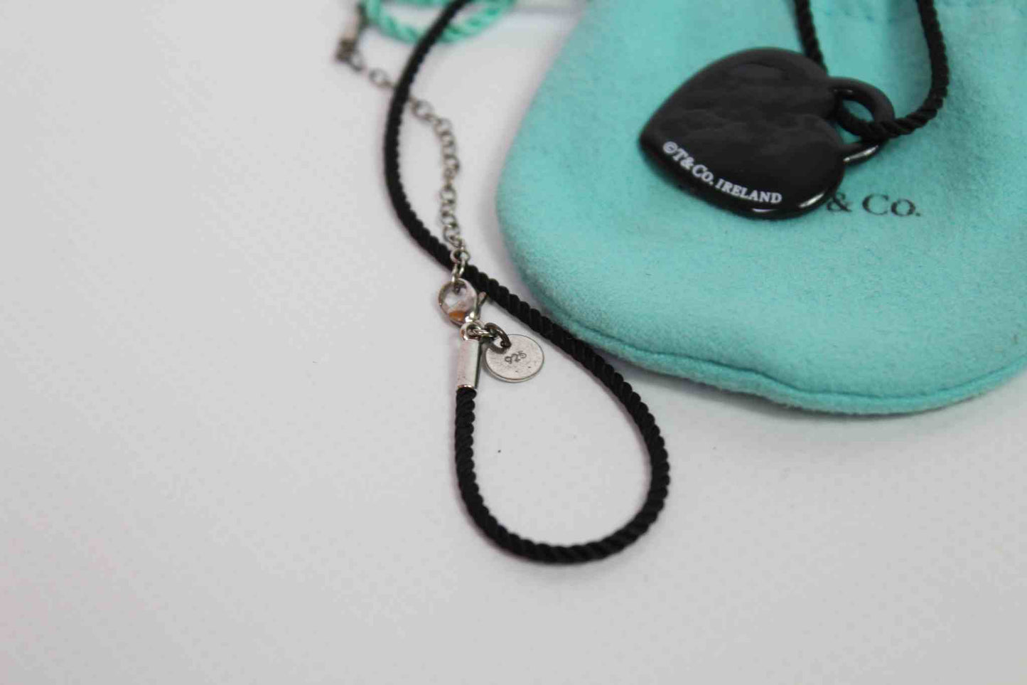 Tiffany & Co. Heart Dogtag Necklace with black cord and signature pouch.