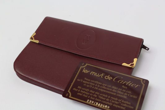 Bordeaux red Cartier Portmonee wallet made of leather with card, size 16x10cm.