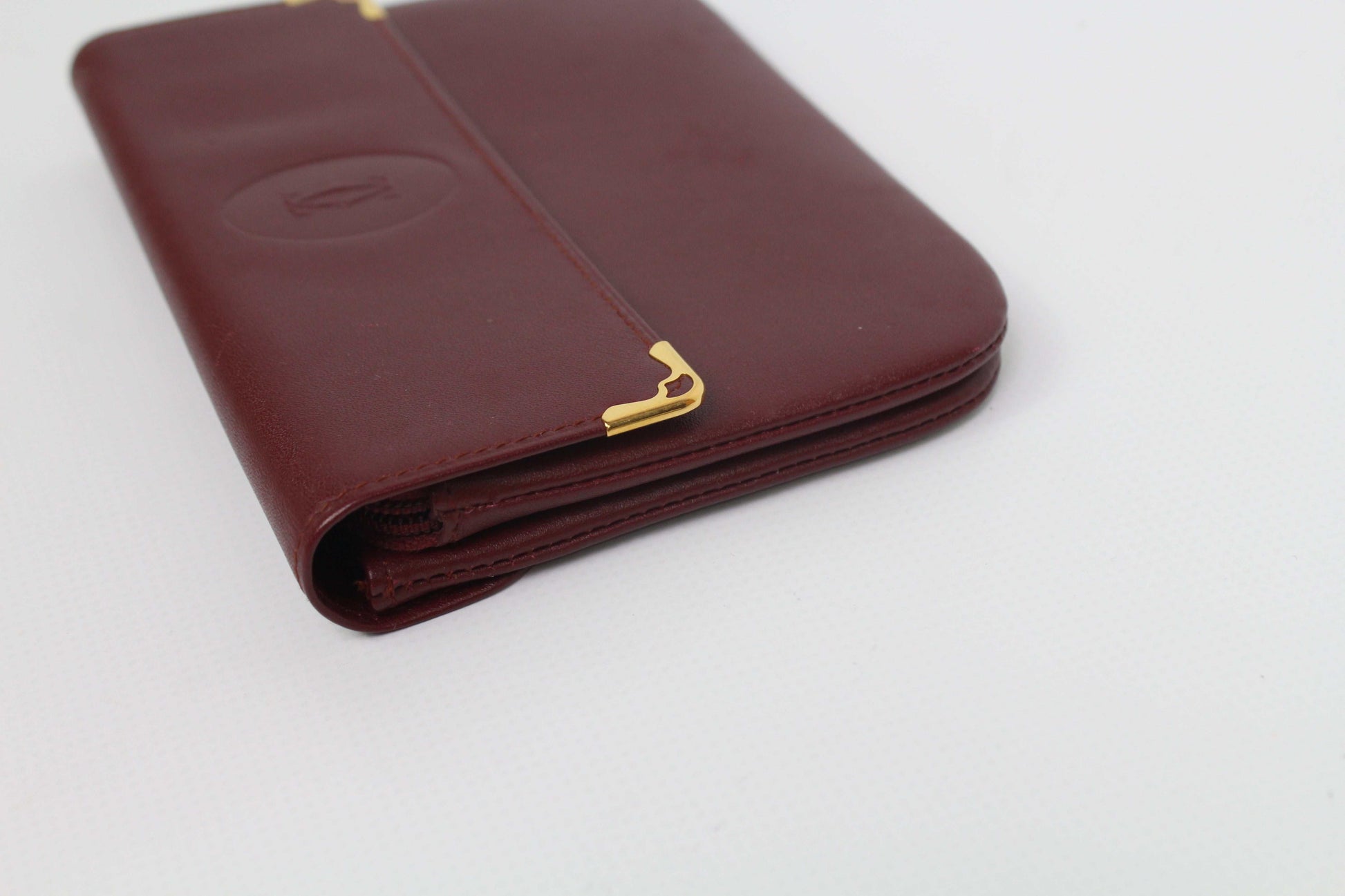 Bordeaux red leather Cartier Portmonee wallet with card holder.