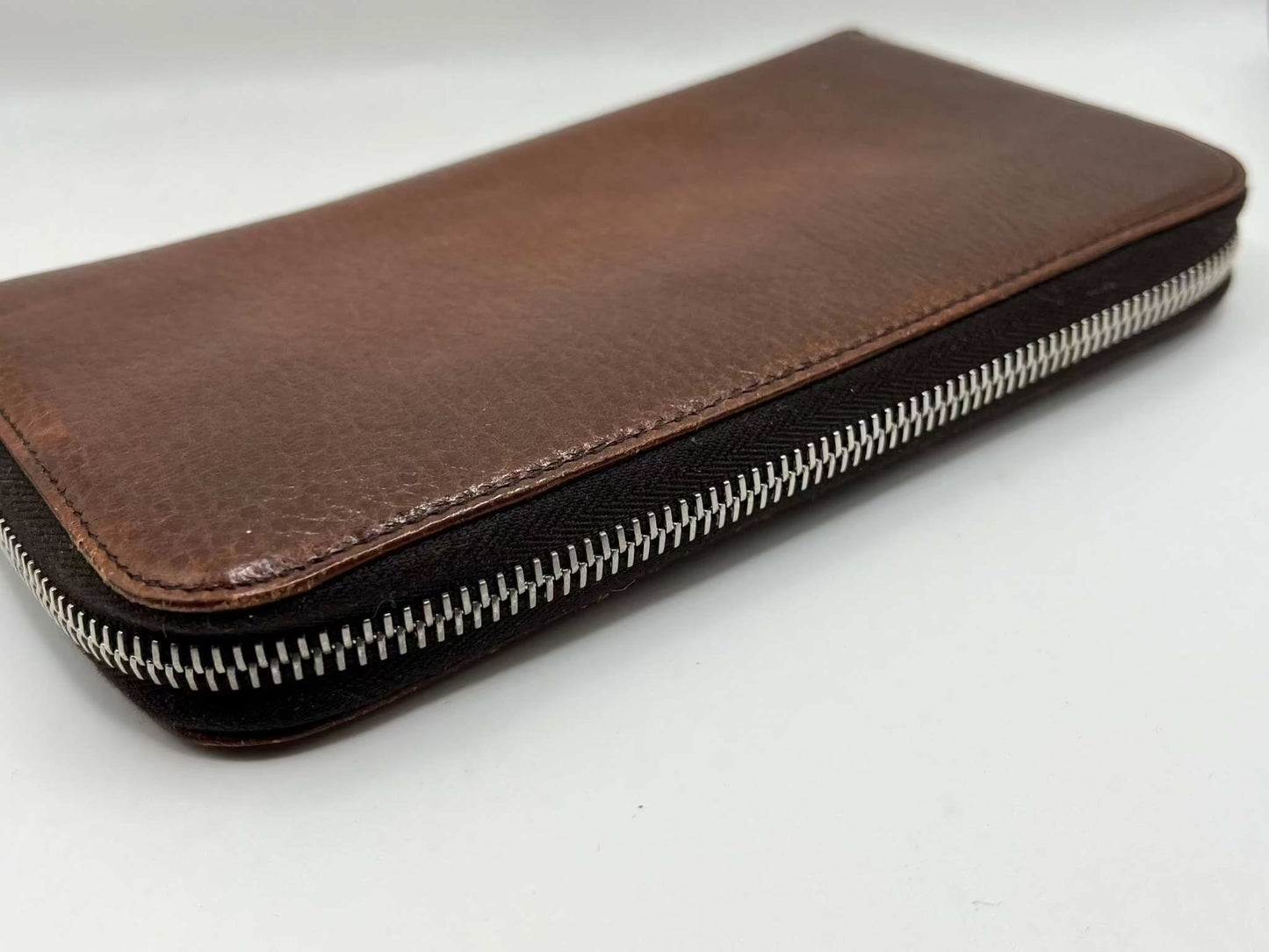 Brown PRADA leather longwallet, zippered design, size 20x10cm.