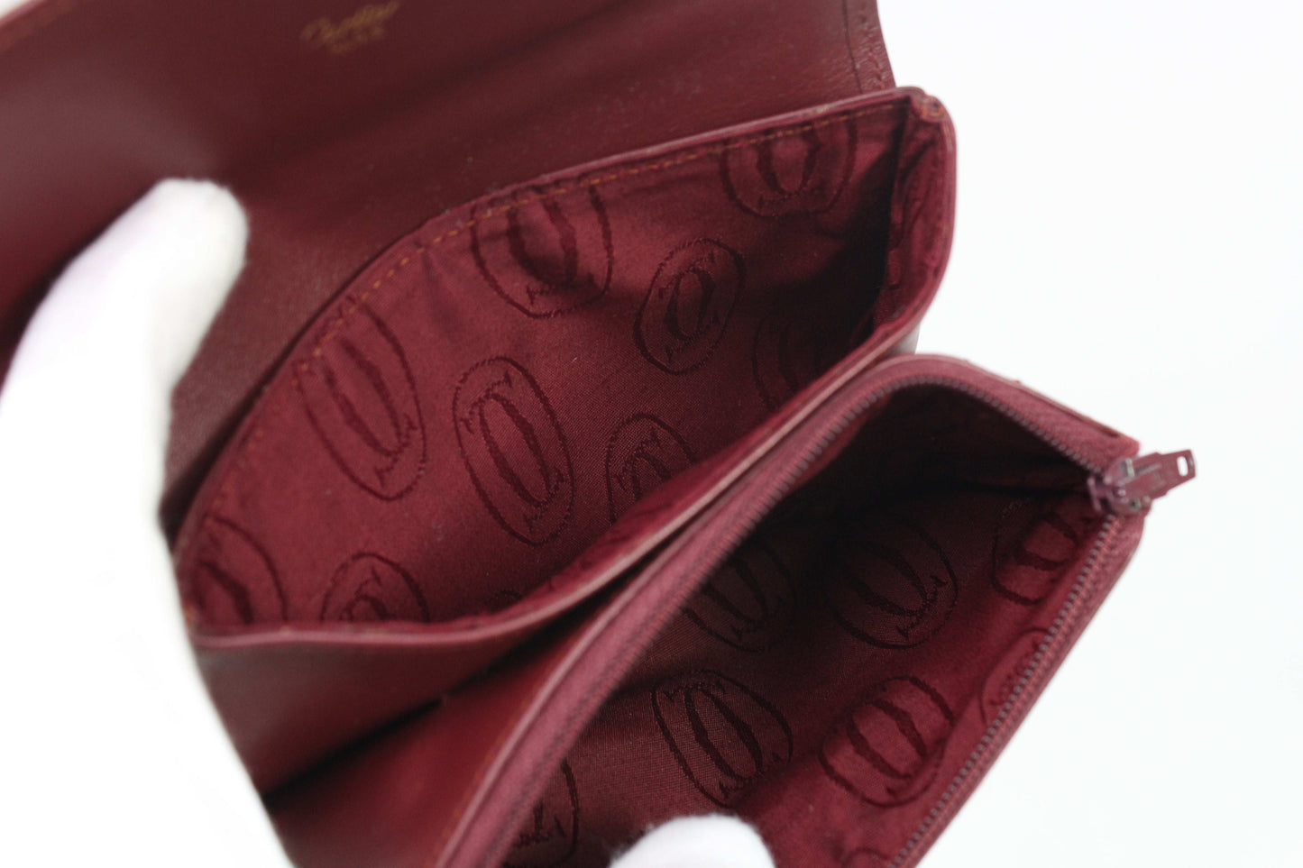 Bordeaux red Cartier Portmonee wallet in leather with card holder.