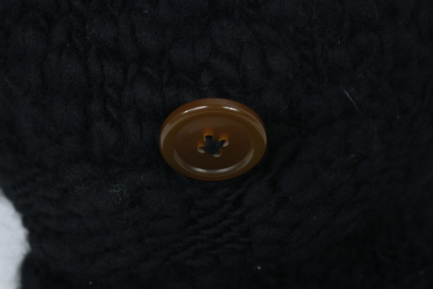 VIVIENNE WESTWOOD black knit wool hat with button detail.