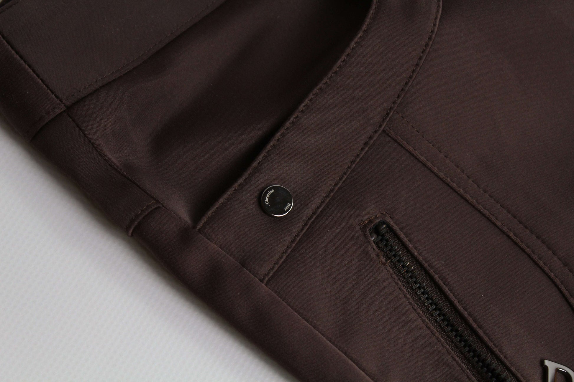 Brown DIOR nylon pants with zipper detail.