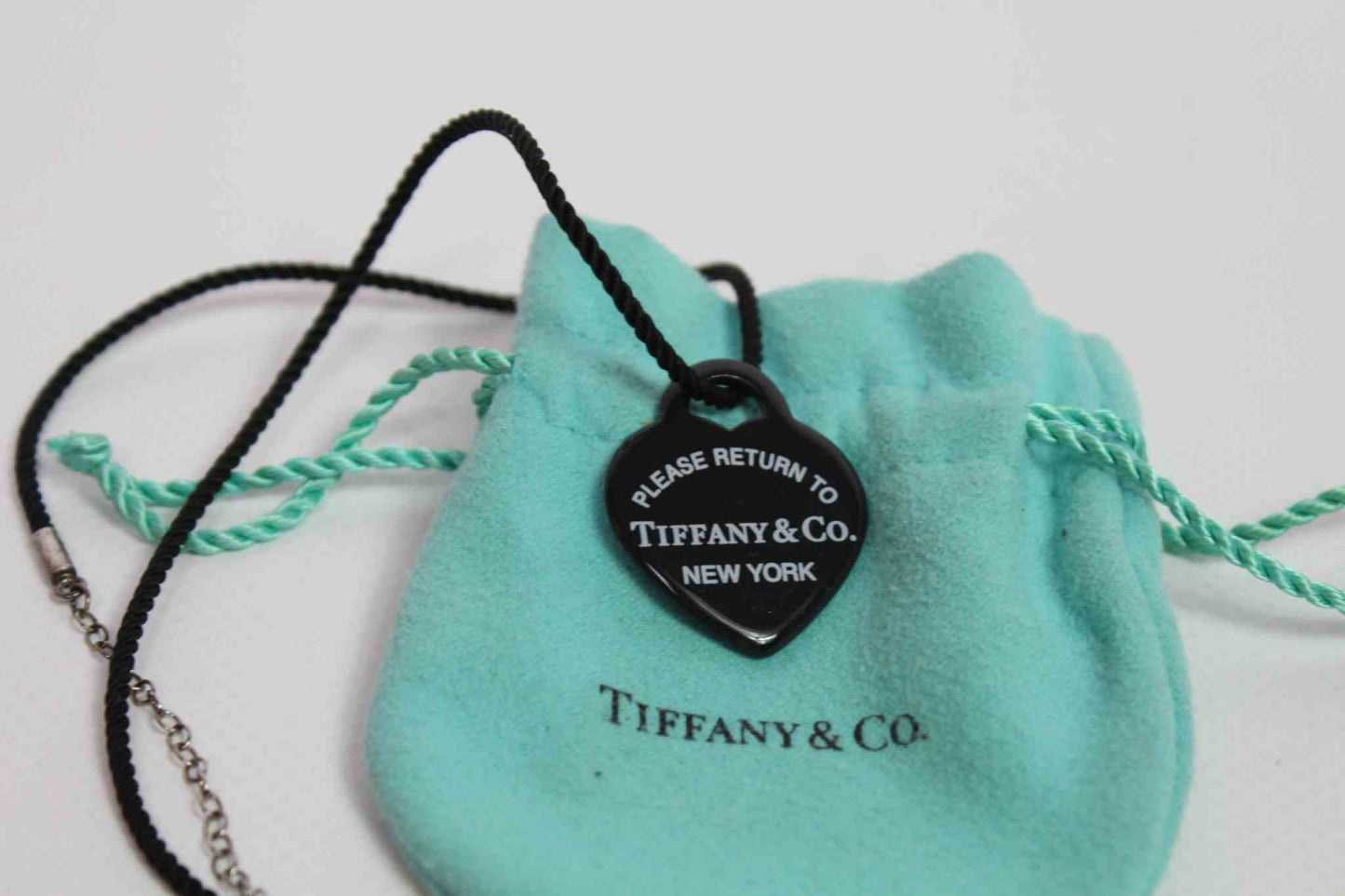 Tiffany & Co. Heart Dogtag Necklace with black pendant and turquoise pouch.